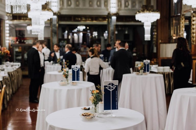 Guests networking at branded standing tables during a congress reception