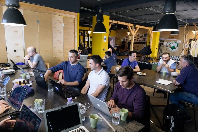 Team working together at long tables in a co-working space